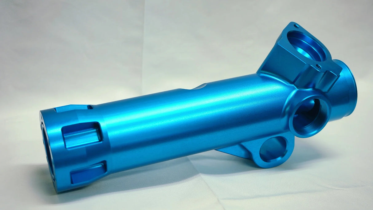 Blue metal cylindrical component on a light gray background