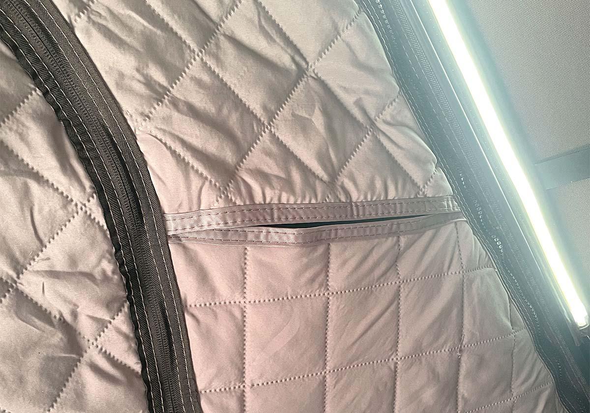 Quilted liner with a zipper on a neutral background