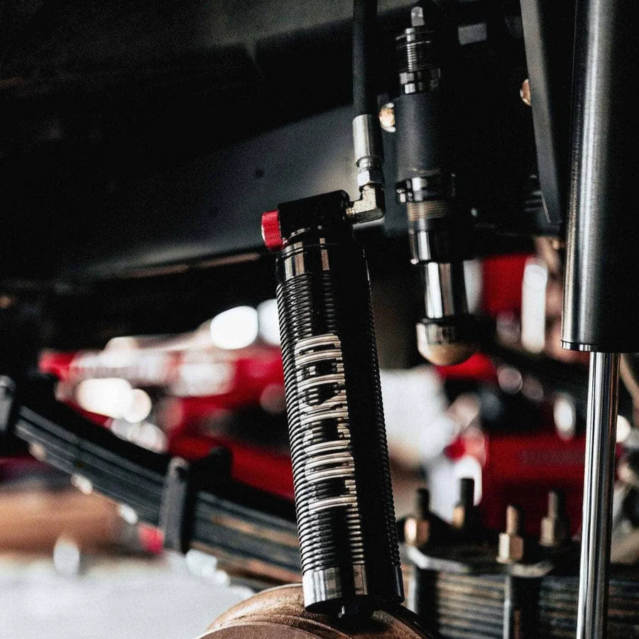 Close-up of a suspension fork on a motorcycle with blurred background
