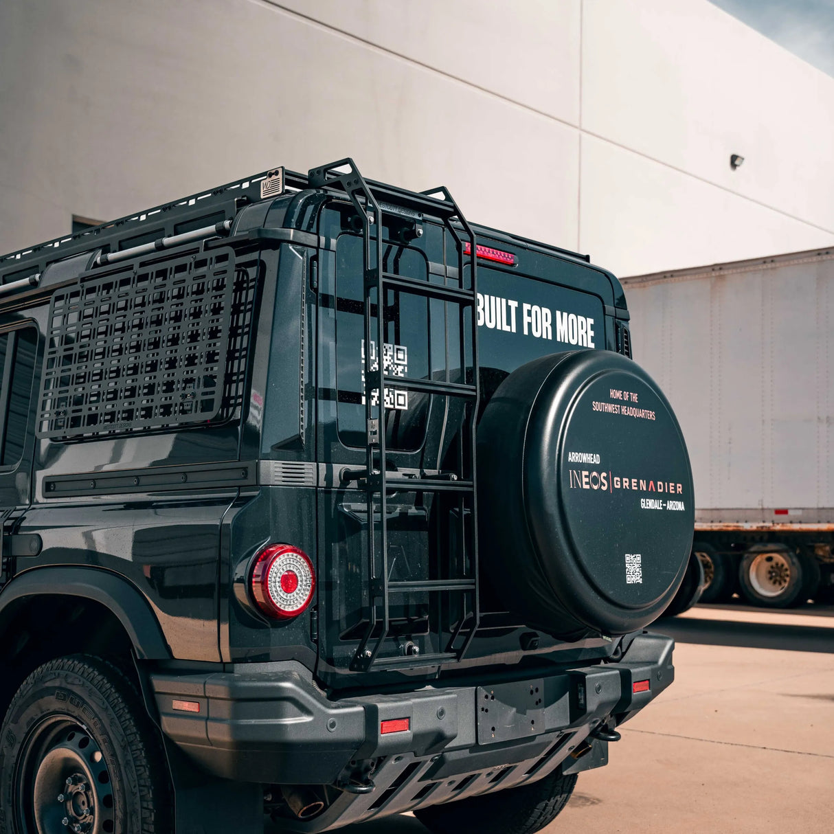 Black tactical vehicle with INEOS Grenadiers branding.