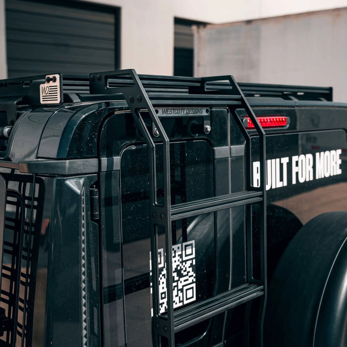 Black SUV and ladder with Westcott Designs branding.