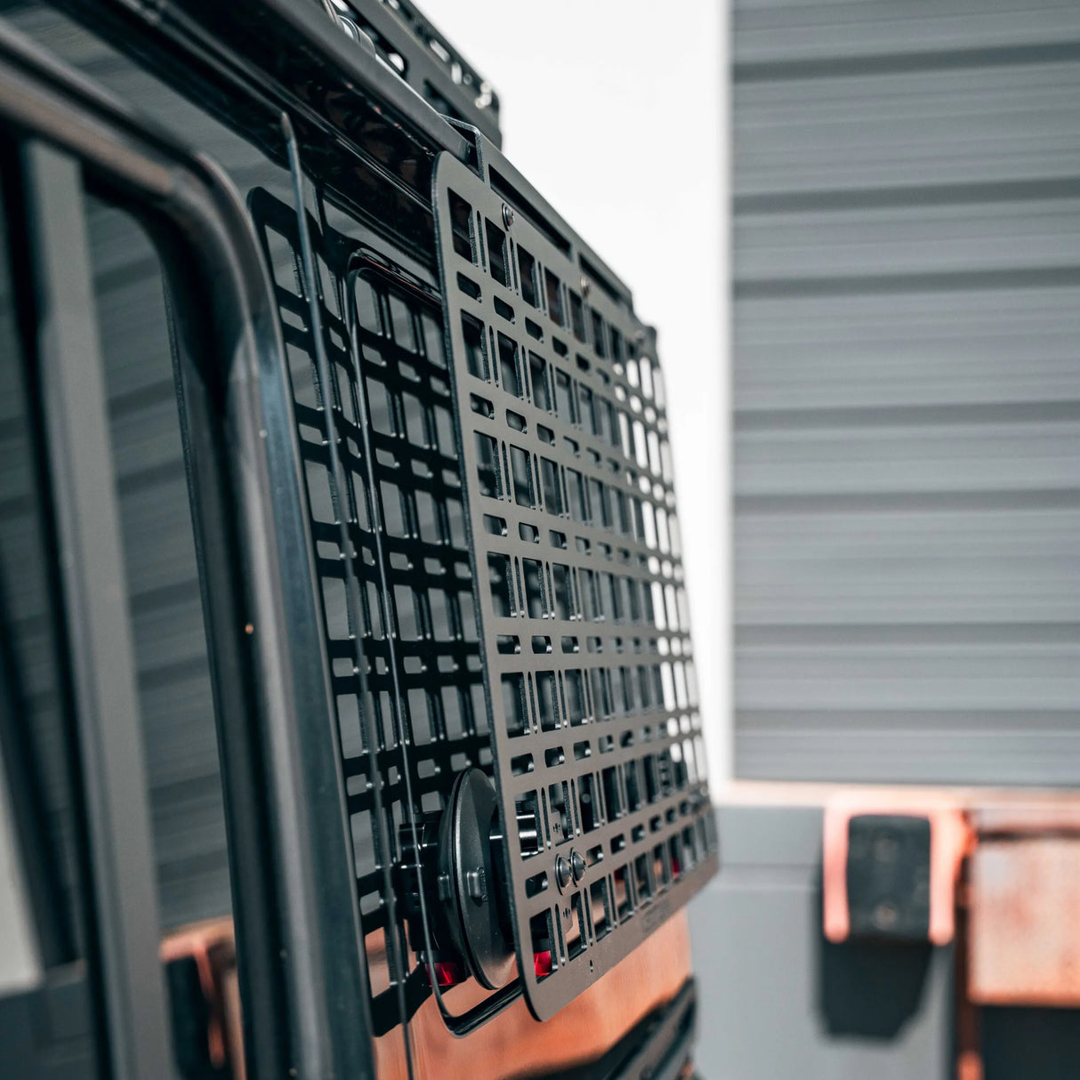 Close-up of a vehicle grille with a blurred background