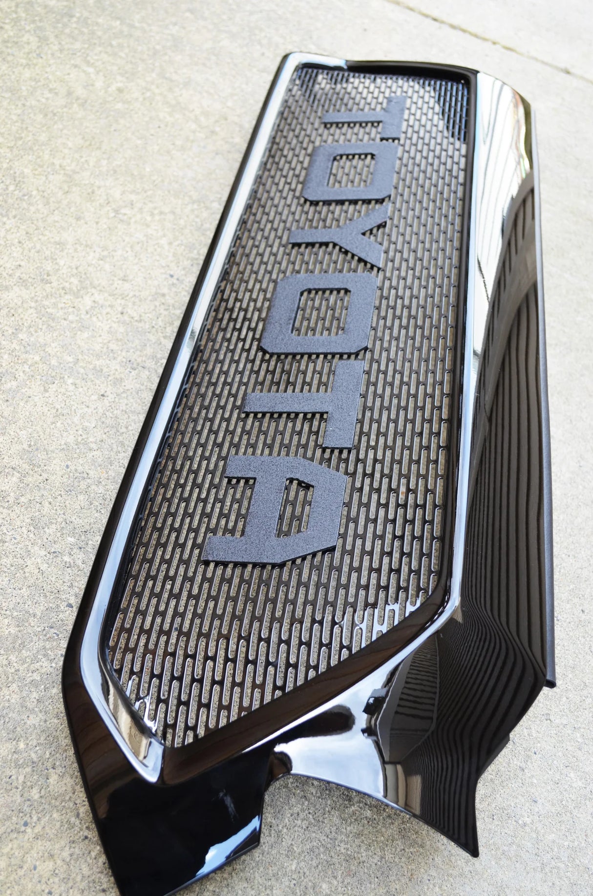 Car grille with 'Hydra' branding on a light gray background