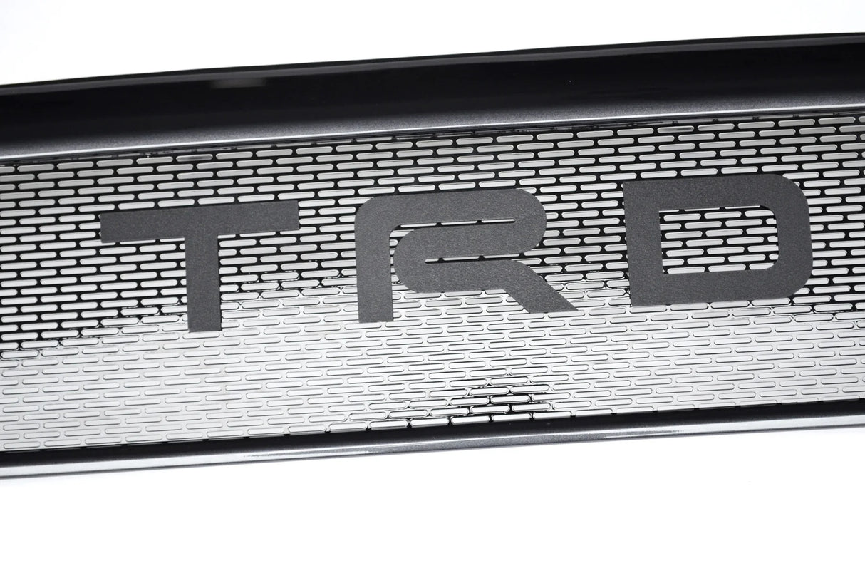 Metallic grille with 'TRD' logo on a white background