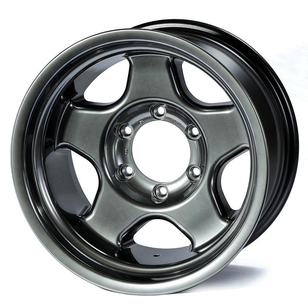 Metallic gray alloy wheel on a white background