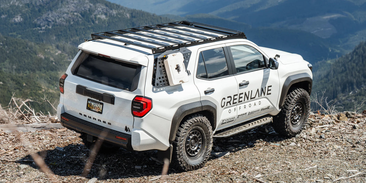 White SUV with branding on a mountainside