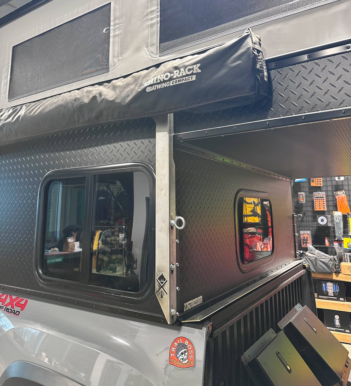 Metal awning bracket on black Project M camper