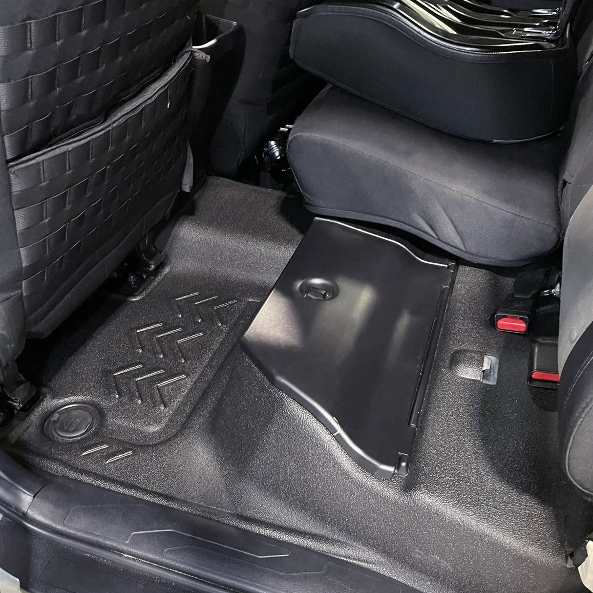 Rear driver side flooring showing close fitment around rear bin