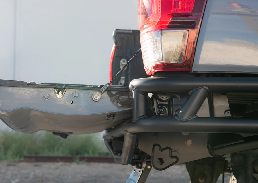 Close-up of a vehicle's rear bumper and tail light with a blurred background