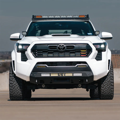 White 2025 Tacoma with stealth bumper on a road