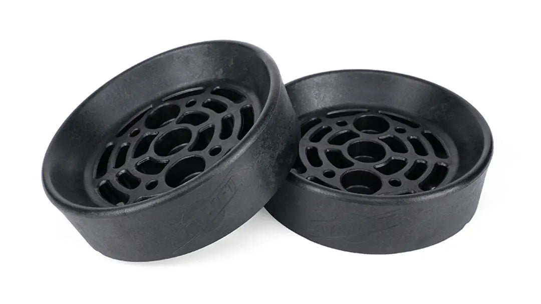 Two black plastic components with circular holes on a white background