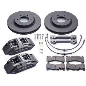 A set of brake kit components including four brake rotors, four brake calipers, brake pads, and mounting hardware.