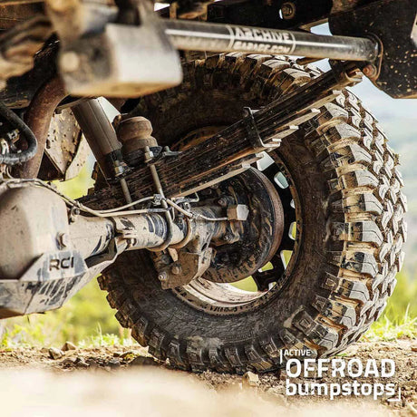 Close-up of an off-road vehicle's suspension system with 'Active Offroad Bumpstops' branding.