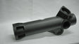 Black metal mechanical component on a gray background