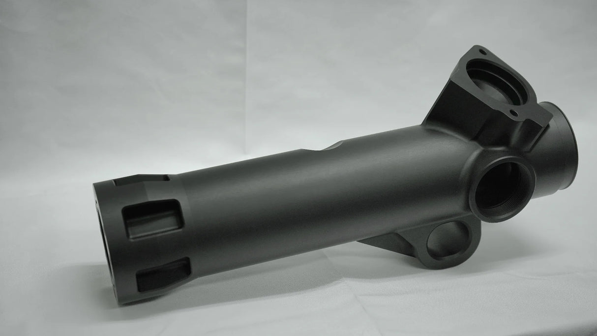 Black metal mechanical component on a gray background
