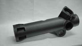 Black metal mechanical component on a gray background