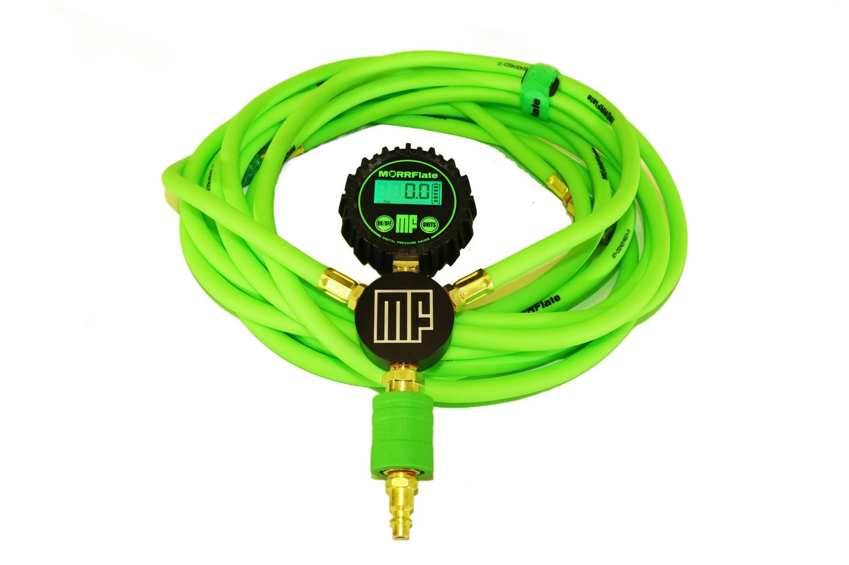 Green tire pressure gauge with hose on a white background