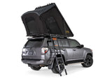 Gray SUV with a rooftop tent and ladder on a white background
