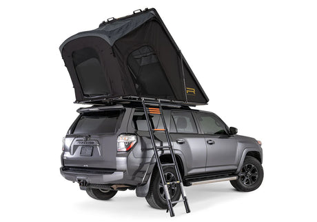 Gray SUV with a rooftop tent and ladder on a white background