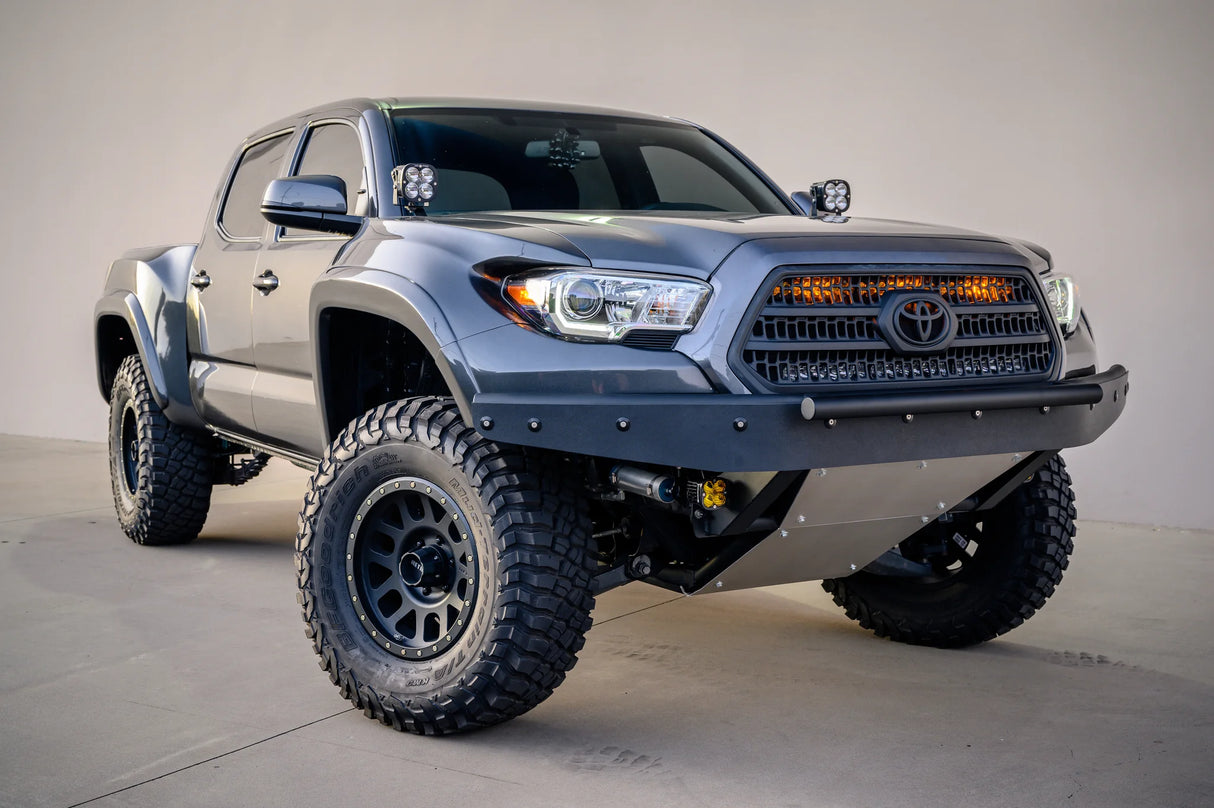 Gray Toyota truck with off-road tires on a concrete floor