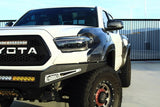 White Toyota truck with black accents on a clear day