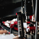 Close-up of a suspension fork on a motorcycle with blurred background