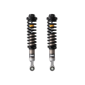 Black, silver and yellow coilovers on a white background
