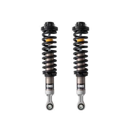Black, silver and yellow coilovers on a white background