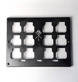 Black metal panel with cut-out shapes on a white background