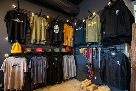 Display of Overland Outfitters t-shirts and accessories in a store