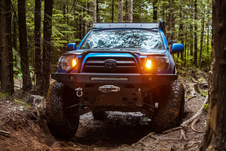 Toyota truck on a dirt road in a forest