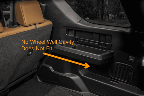 Car interior with a wheel well cavity labeled 'No Wheel Well Cavity Does Not Fit' and an arrow pointing to it.