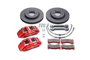A set of red PowerBrake X-Line 6-piston off-road calipers with accompanying high-performance brake pads, 370x34mm 56-vane discs, and stainless steel braided brake lines, along with billet caliper mounting brackets and mounting hardware.
