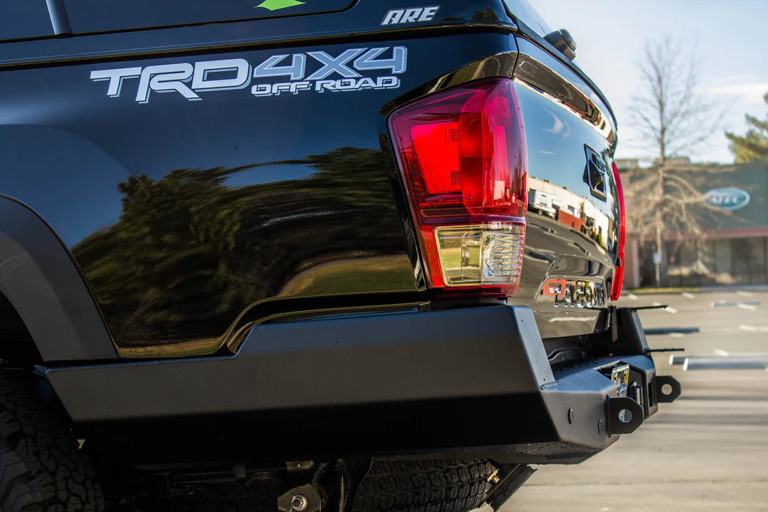Truck rear with 'TRD 4X4 Off Road' branding in a parking lot.