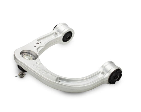 Metal vehicle suspension control arm on a white background