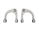 Two metallic control arms on a white background