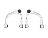 Two metal suspension control arms on a white background