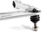 close up of a ball joint on an upper control arm on a white background