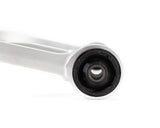Close-up of a mechanical component with a white shaft and black rubber bushing on a white background