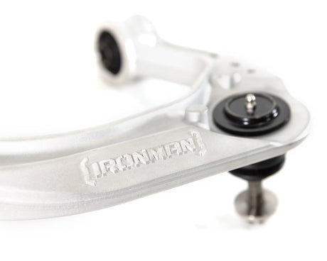 Close-up of an upper control arm with 'Ironman' branding on a white background