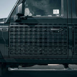Close-up of a black vehicle grille with INEOS branding