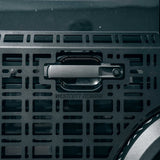 Close-up of a dark metallic handle with the brand name WESTCOTT DESIGNS embossed below it, mounted on a perforated metal panel.