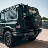 Black off-road vehicle with a spare tire on a clear day