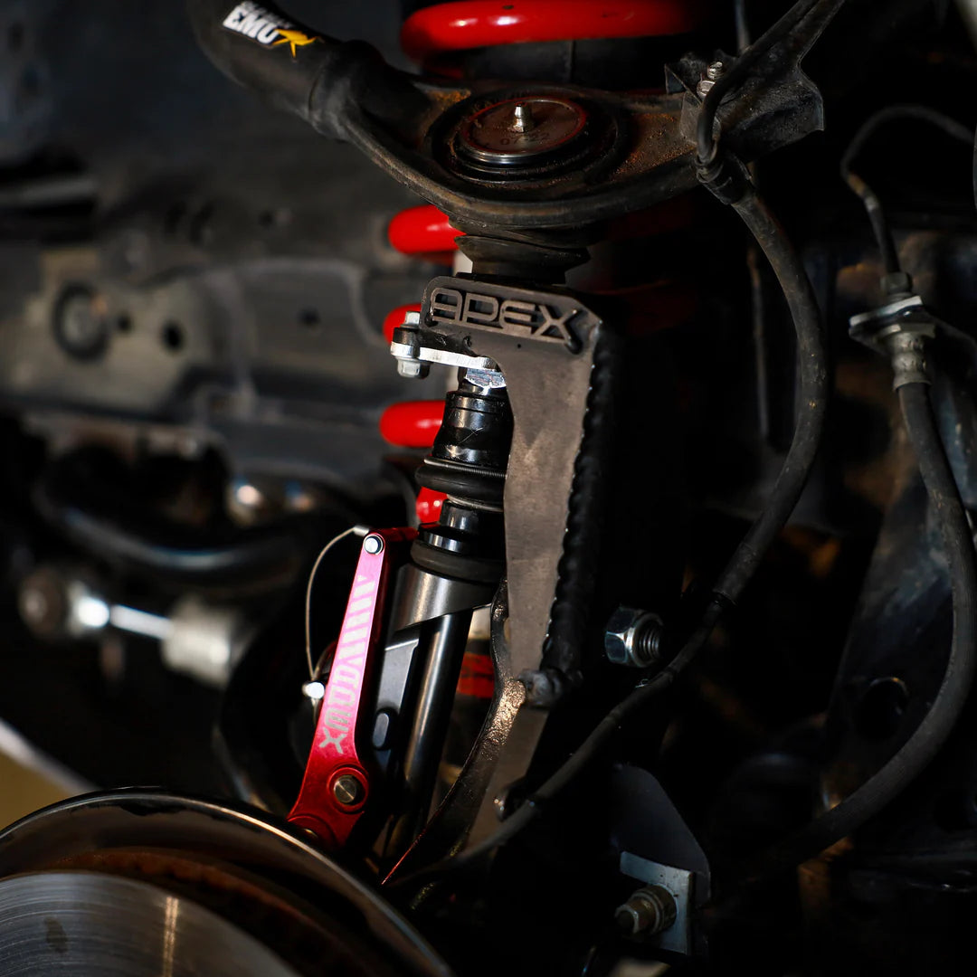 Close-up of a car suspension system with 'APEX' branding.