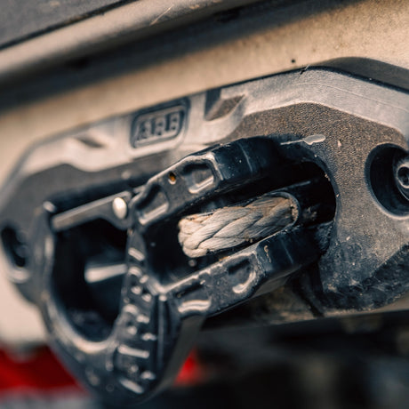 Close-up of a winch with visible branding on a textured background