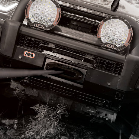Front bumper of a vehicle with ARB lights installed on a natural background