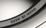 Close-up of a rim with 'MADE IN JAPAN' engraving on a metallic surface.