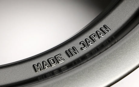 Close-up of a rim with 'MADE IN JAPAN' engraving on a metallic surface.