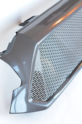 Close-up of a car grille with a textured pattern on a white background