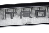 Metallic grille with 'TRD' logo on a white background